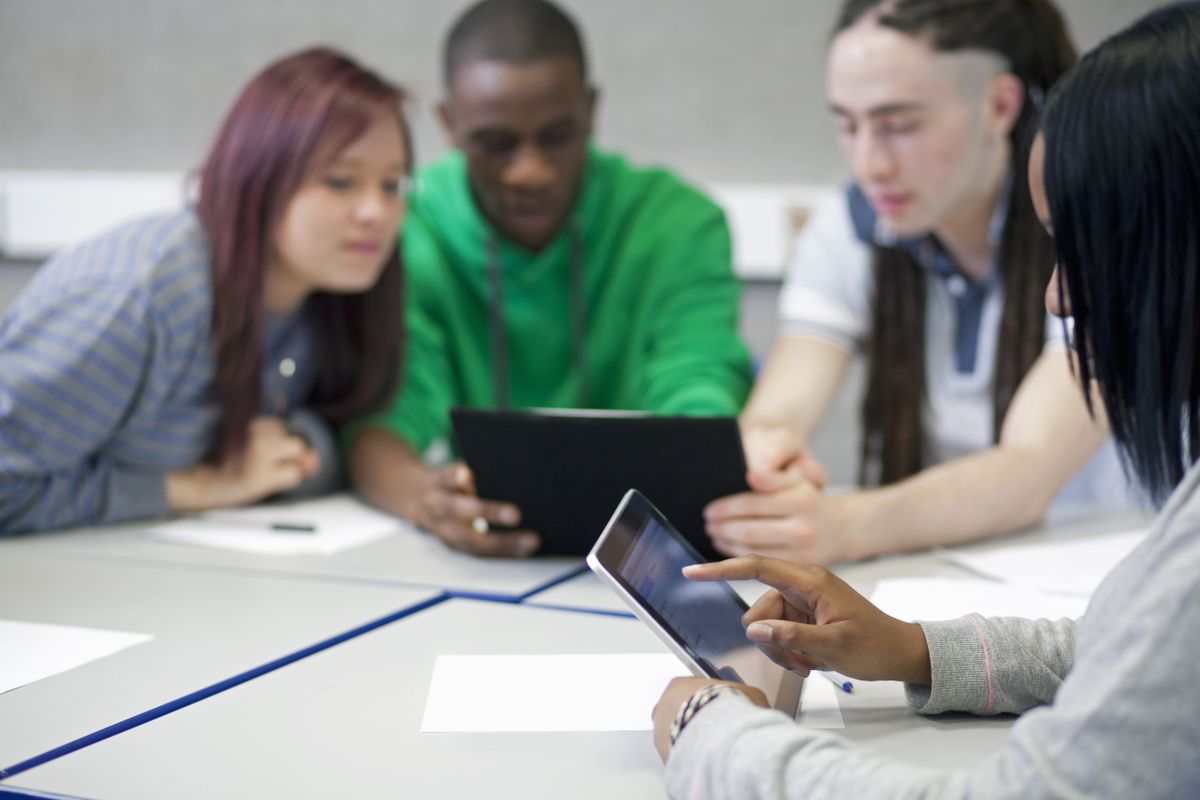 A-level results 2023: Young woman using a digital tablet in a classroom