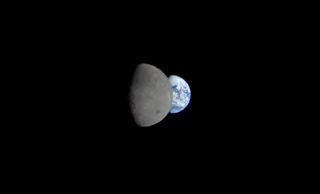 NASA's uncrewed Orion capsule captured this shot of the moon crossing in front of Earth on Nov. 28, 2022, the 13th day of the Artemis 1 mission.