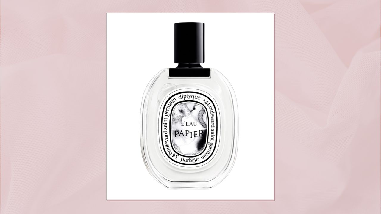 A close up of Diptyque&#039;s L&#039;Eau Papier Eau de Toilette in a pastel pink, paper-effect template