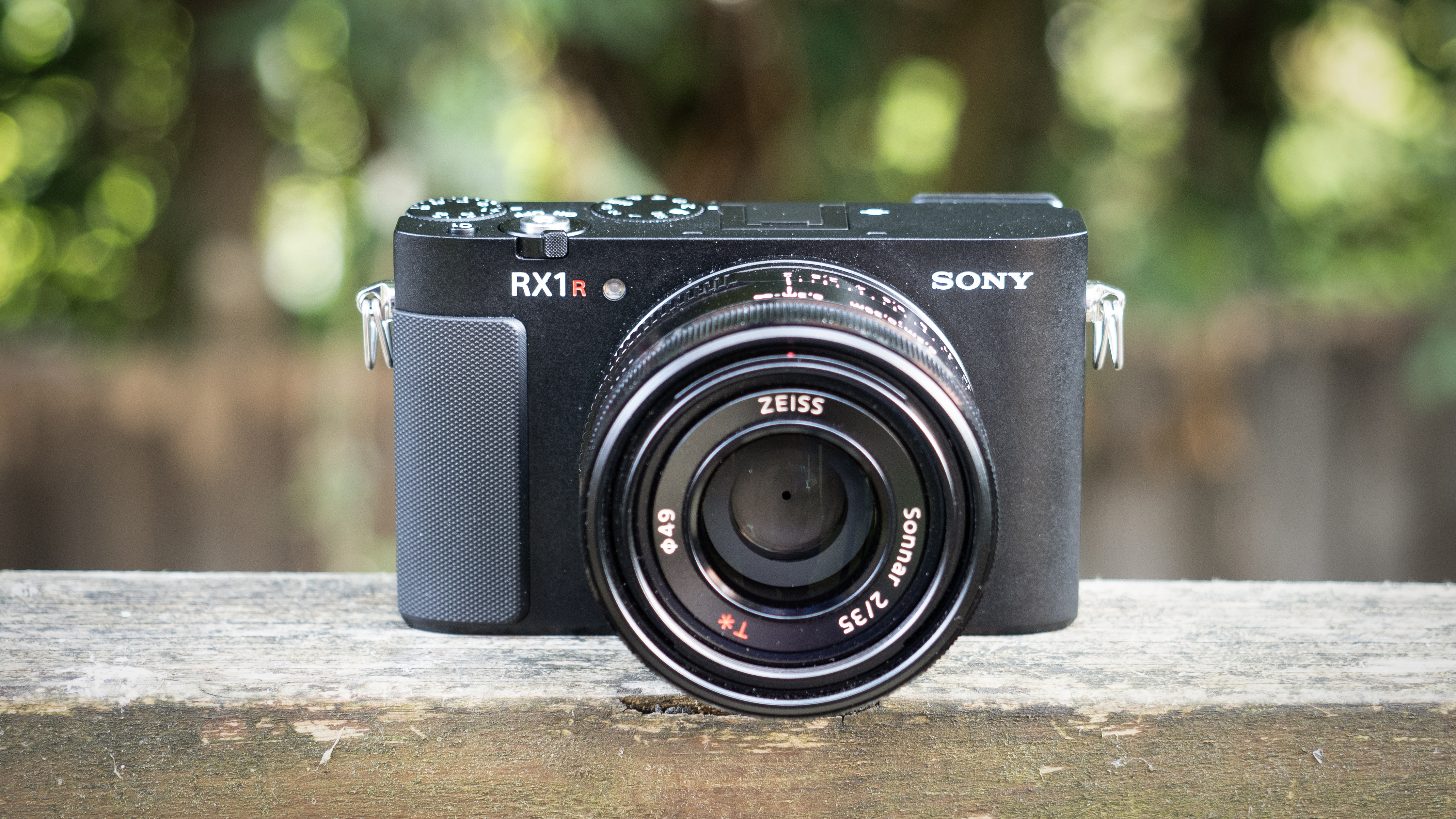 Sony RX1R III on a wooden surface in a woodland environment