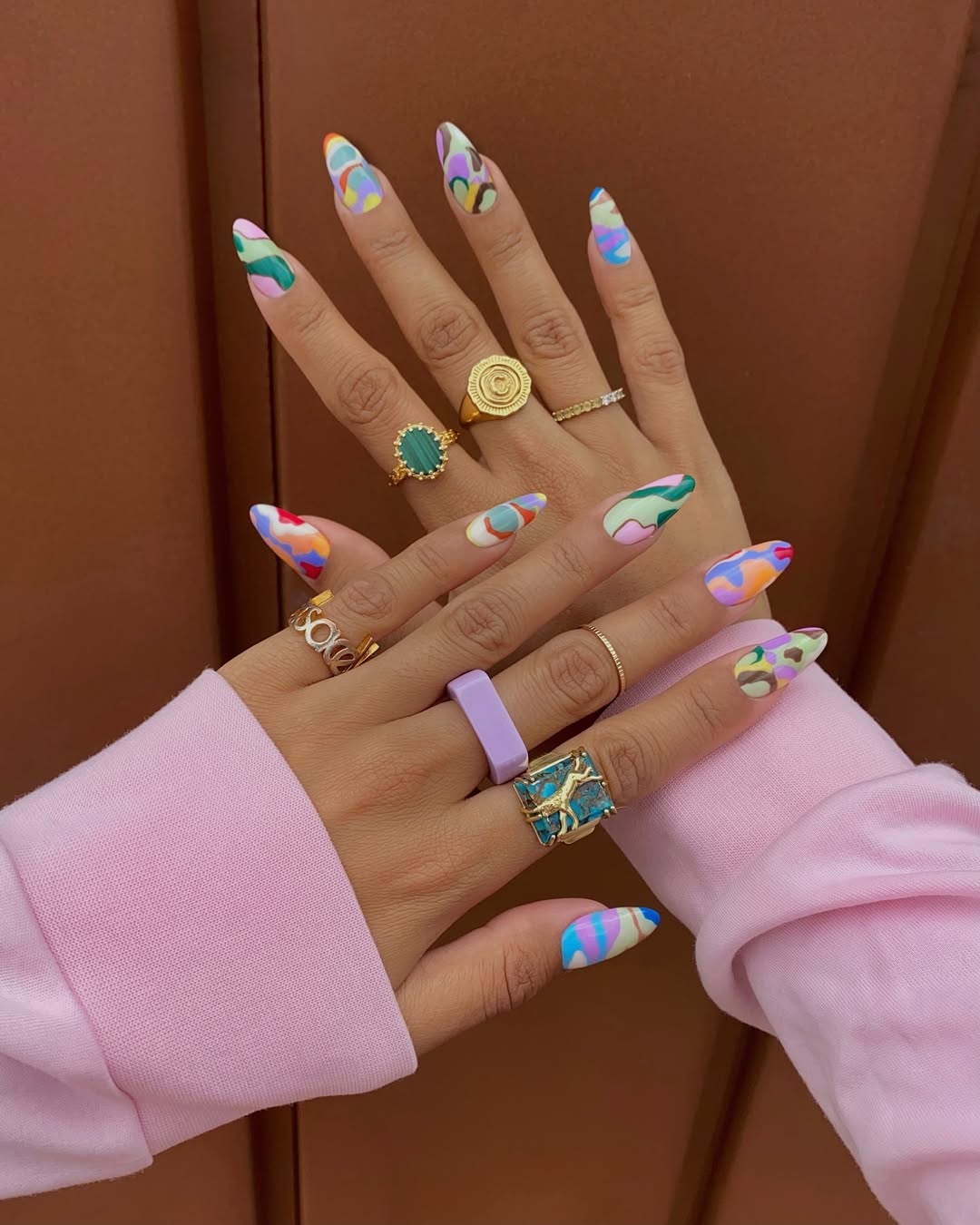 A bright, marbled manicure on content creator Celeste Vignois