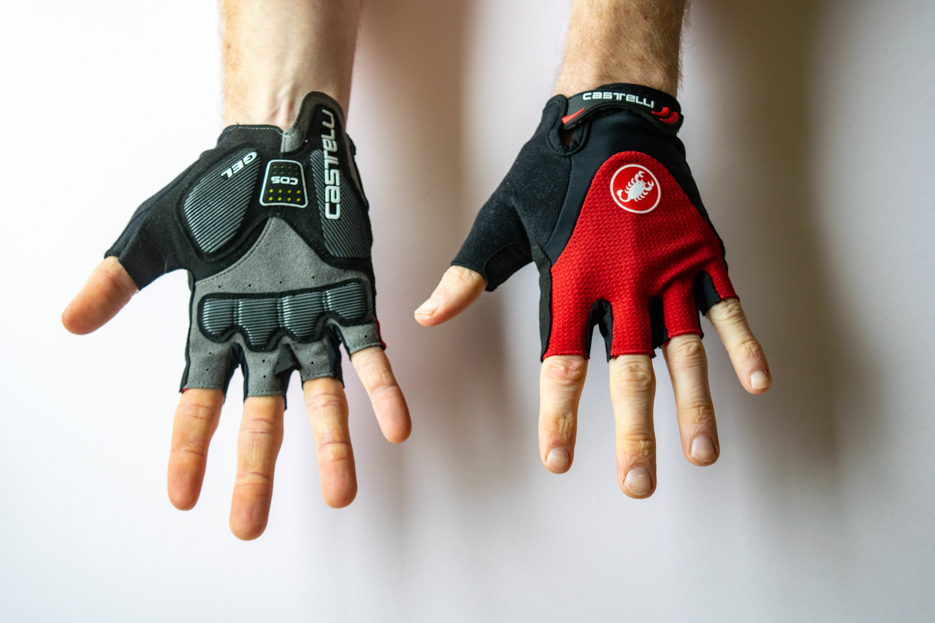 A rider wearing Castelli Arenberg 2 Gloves with hands showing the palm and the face