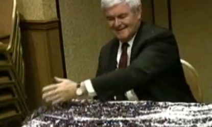 Newt Gingrich sweeps away a pile of sparkly bits after being glitter-bombed in May.