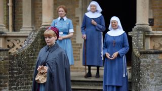 Rosalind, Phyllis, Sister Monica Joan and Sister Julienne standing on the steps of Nonnatus House in their uniforms