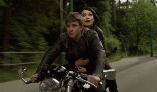 Tron: Legacy Sam Flynn and Quorra riding his motorcycle