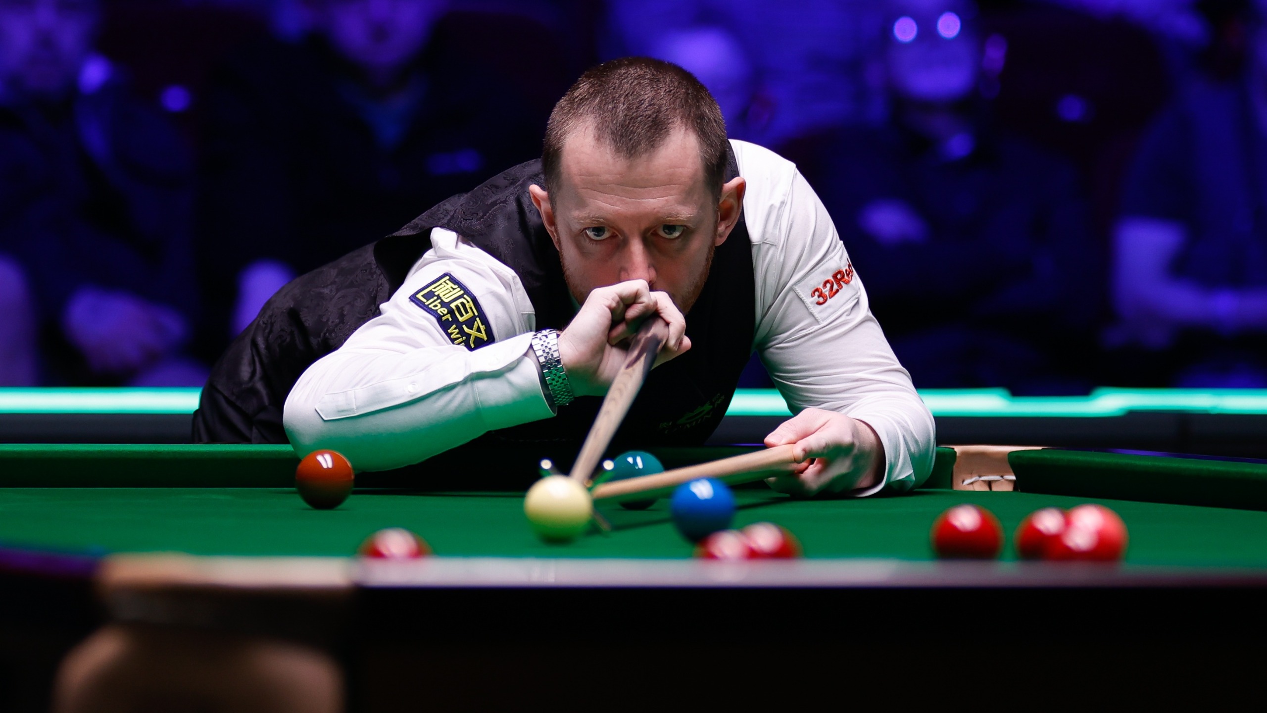 Mark Allen of Northern Ireland in black waistcoat gets down on the table and plays a shot in the quarterfinal match ahead of the Northern Ireland Open 2026 in Belfast (Photo by Tai Chengzhe/VCG via Getty Images)
