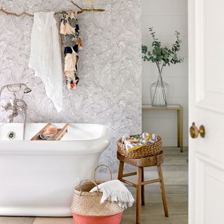 bathroom with grey marble wallpaper bathtub and buckets