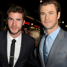 Actors Liam Hemsworth (L) and Chris Hemsworth arrive at the premiere of Marvel's "Thor: The Dark World" at the El Capitan Theatre on November 4, 2013 in Hollywood, California.