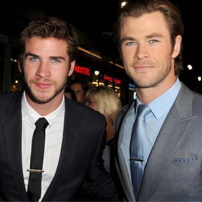 Actors Liam Hemsworth (L) and Chris Hemsworth arrive at the premiere of Marvel's "Thor: The Dark World" at the El Capitan Theatre on November 4, 2013 in Hollywood, California.