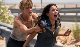 Natalia Reyes screaming as Mackenzie Davis holds her in Terminator: Dark Fate