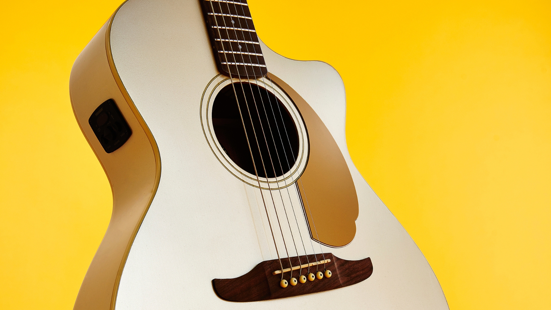 A Fender Newporter acoustic guitar on a yellow background