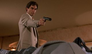 The Living Daylights Timothy Dalton aims his gun at a target on the floor