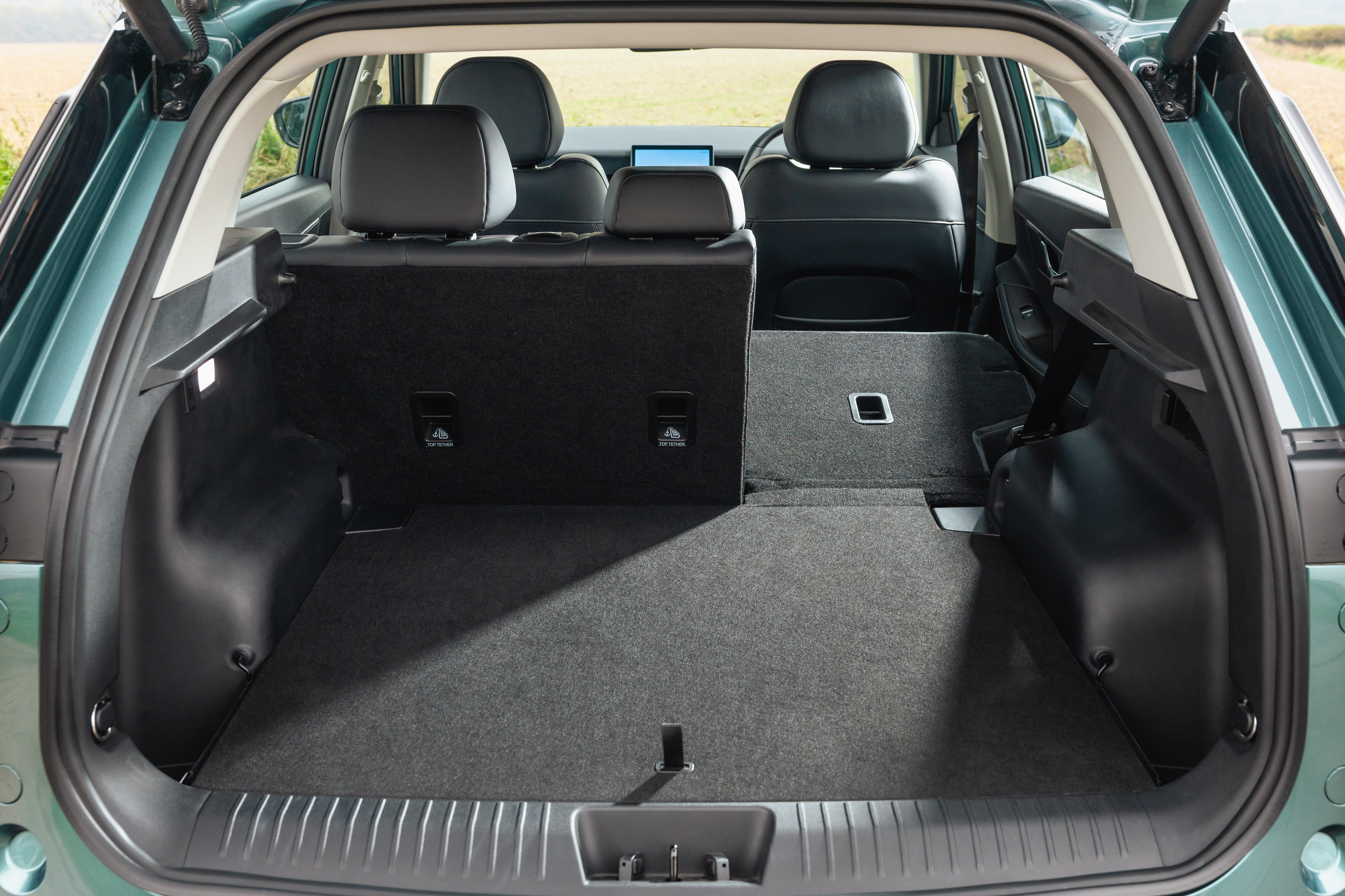 Interior shots of the Jaecoo 5, showing the boot, seats, screen and driving position
