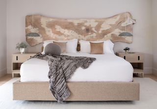a bedroom with a walnut headboard
