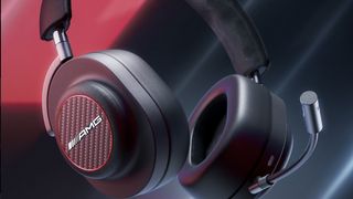 Close-up of Master & Dynamic MG20 wireless gaming headphones on black/red background