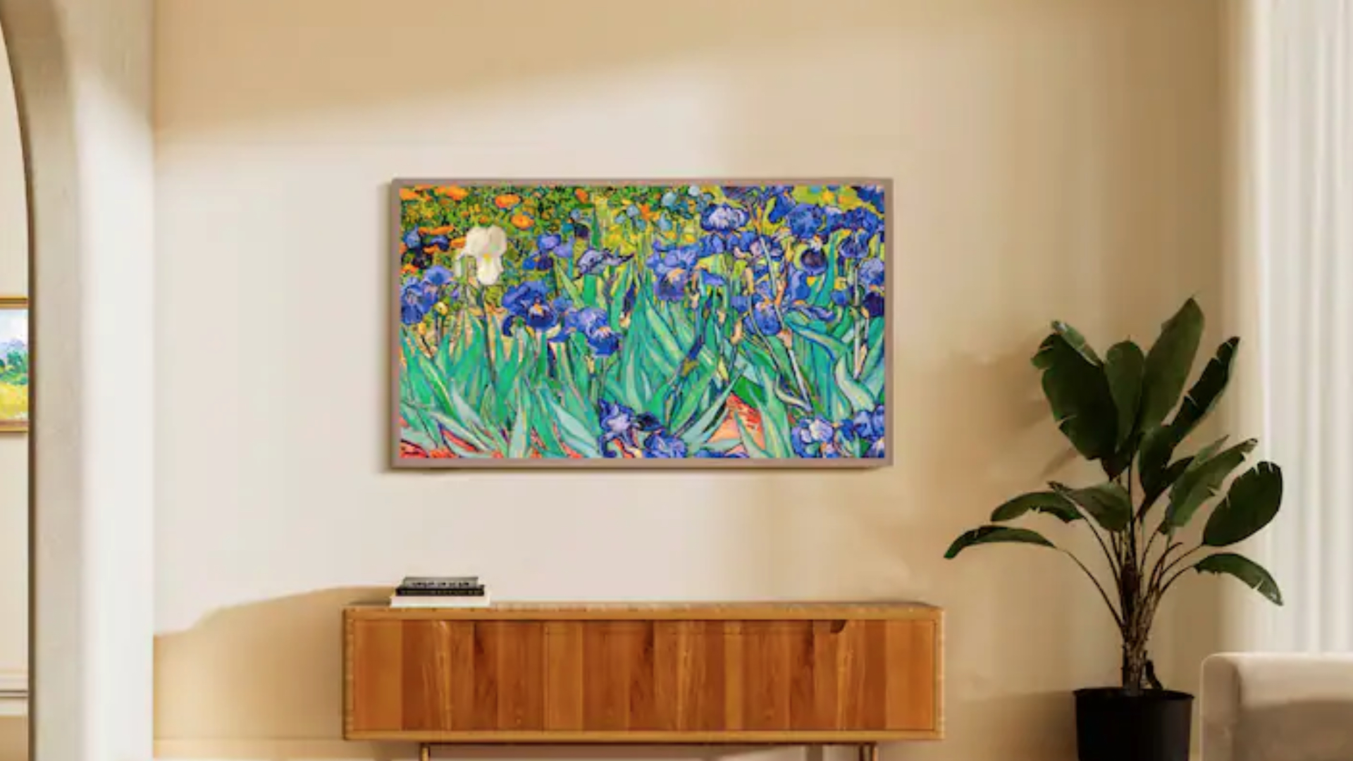 A tv on a home wall above a media console