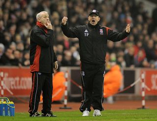 STOKE ON TRENT, ENGLAND - FEBRUARY 24: Stoke's manager Tony Pulis (R) stands alongside assistant Peter Reid as he appeals to a linesman during the FA Cup 5th round match between Stoke City and Manchester City at the Britannia Stadium on February 24, 2010 in Stoke on Trent, England. (Photo by Michael Regan/Getty Images) Lionel Messi