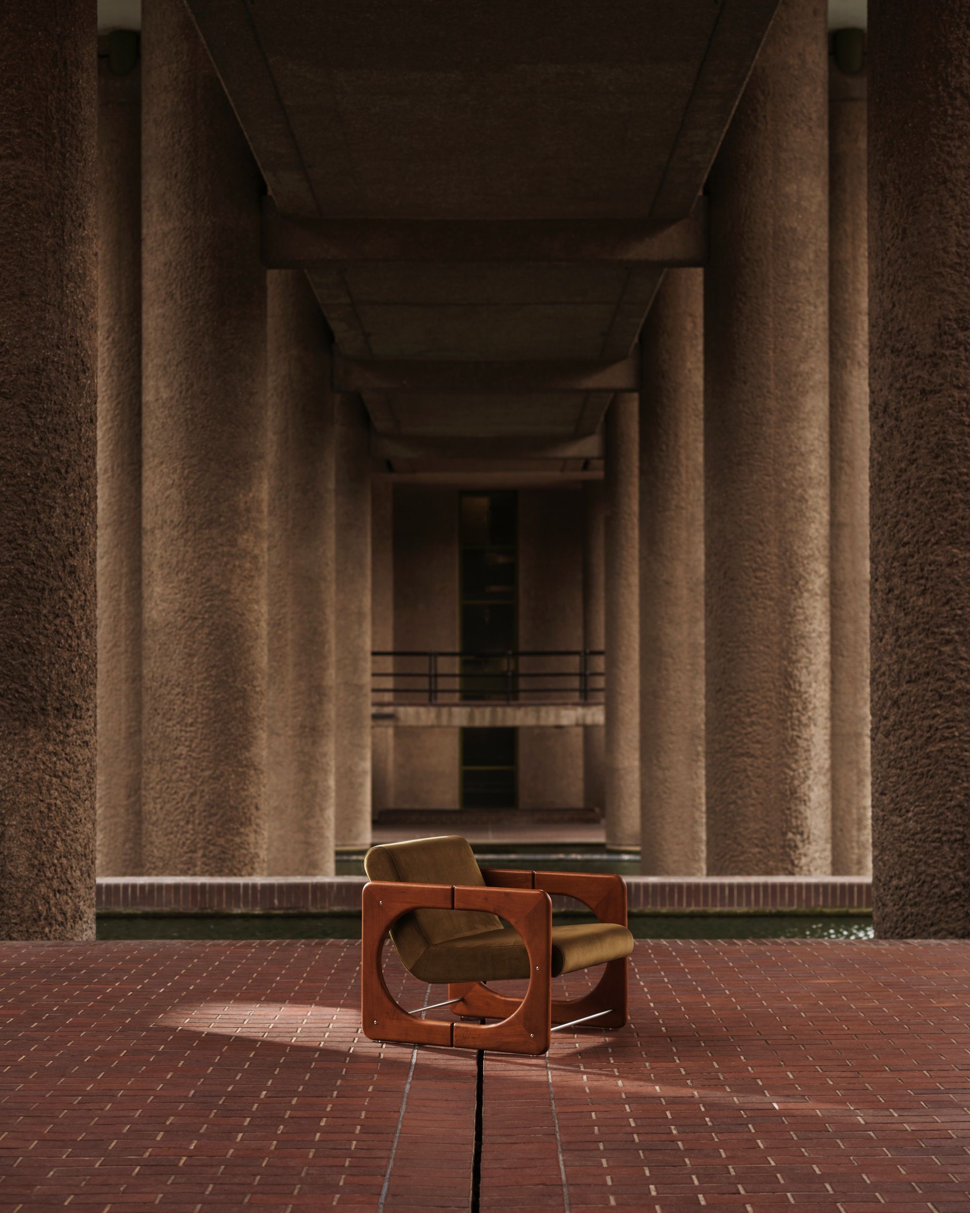 a olive green and wood armchair shot in the barbican