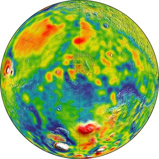 This gravity map of Mars shows the north pole of the planet (center). In this map, white and red colors denote areas of higher gravity, while blue indicates lower gravity regions.