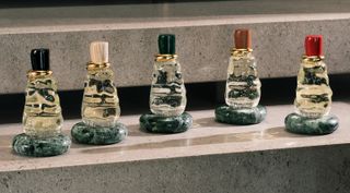 Bottega Veneta fragrance collection on a concrete shelf