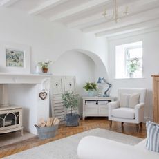 white painted sitting room of an old stone cottage