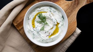 tzatziki dip in bowl on wooden chopping board