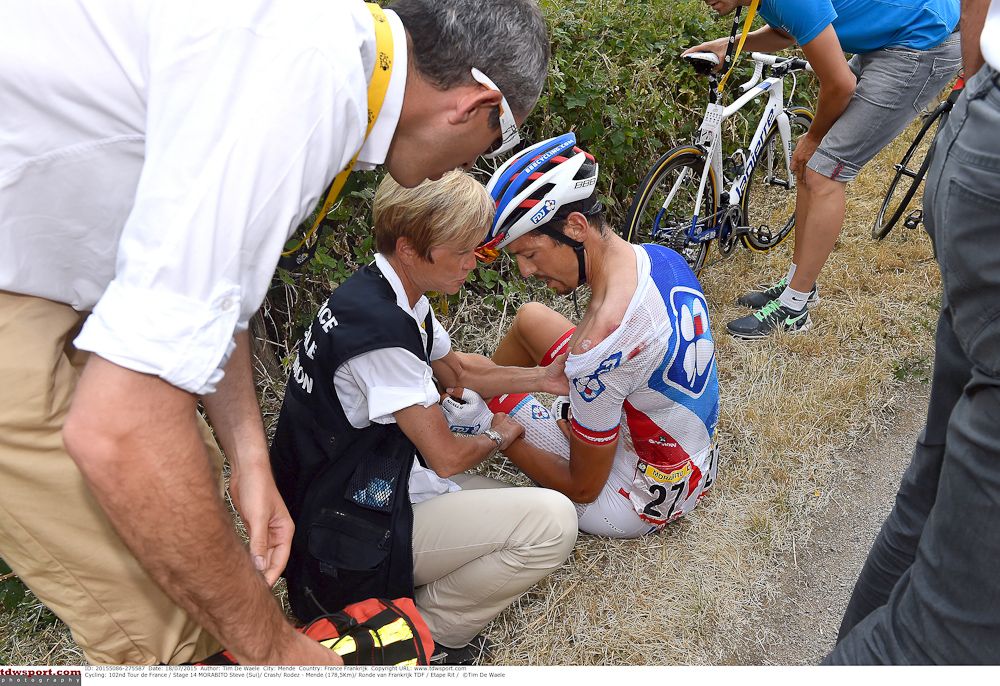 Steve Morabito gets medical attention after crashing during stage 14.