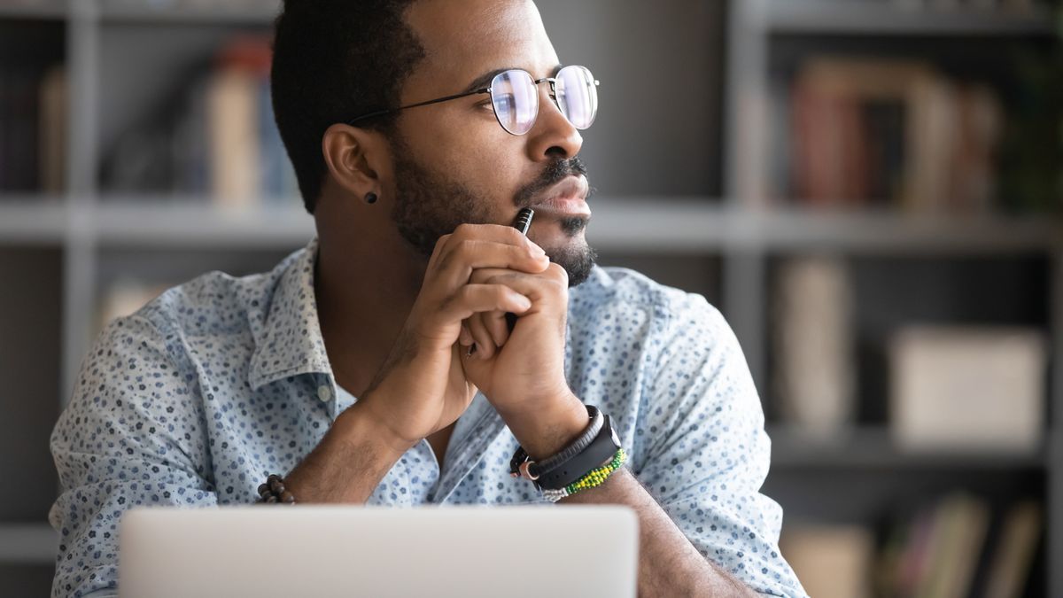 Man in office deep in thought