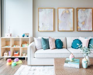 Living room with sofa, framed wall art and toy storage idea