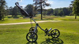 Sun Mountain 2022 Speed Cart V1R Push Cart resting on the golf course without a bag