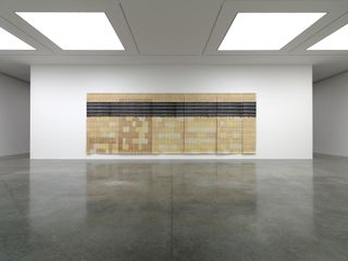 Large-scale artwork on white wall with black floor at White Cube