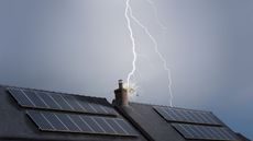 Lightning strikes the roof of a home with solar panels.
