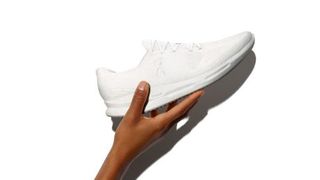 hand-holding-on-cyclon-running-shoe