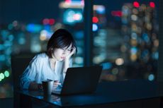 picture of woman working at night