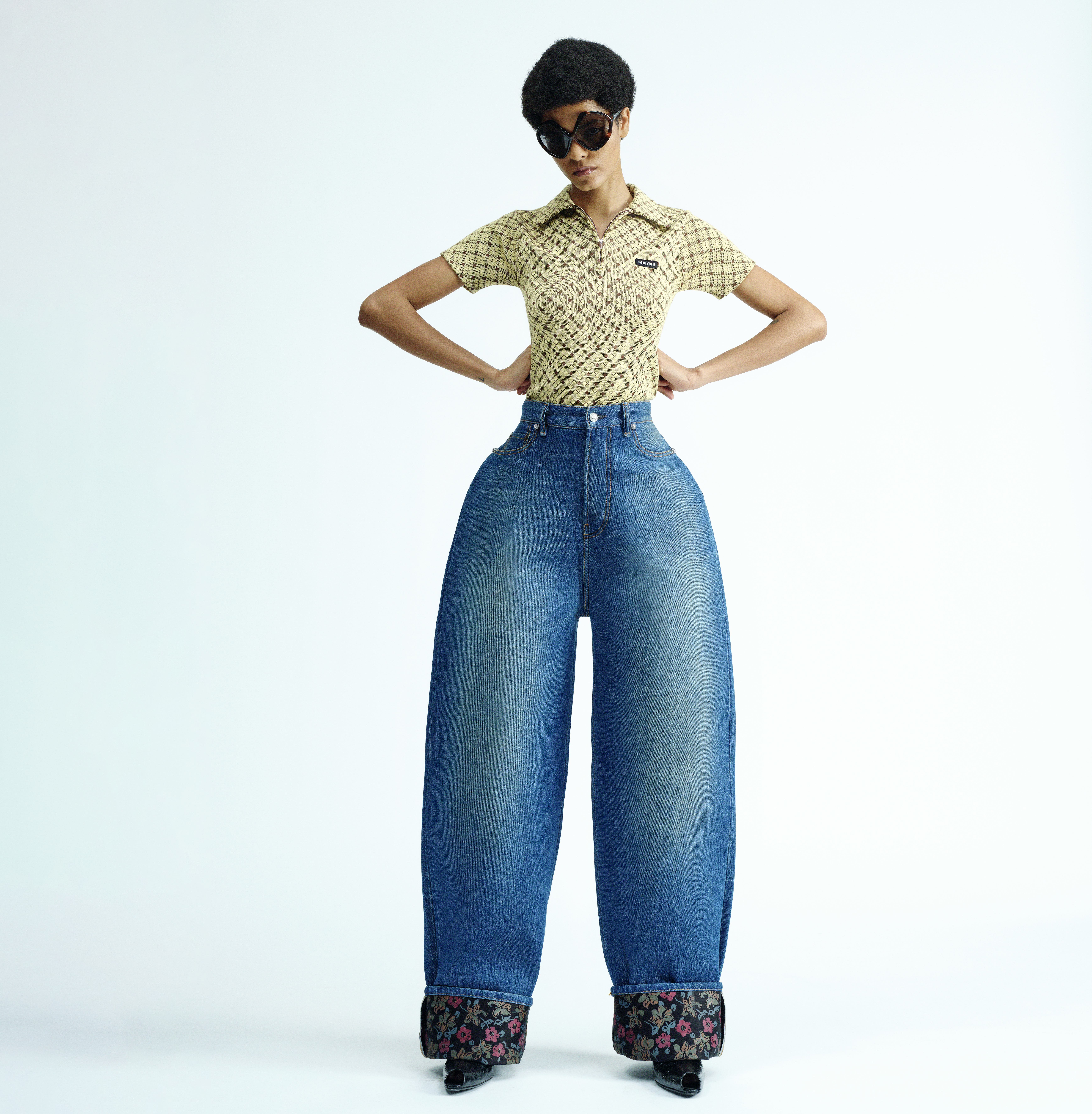 Model wearing a polo top with oversized jeans