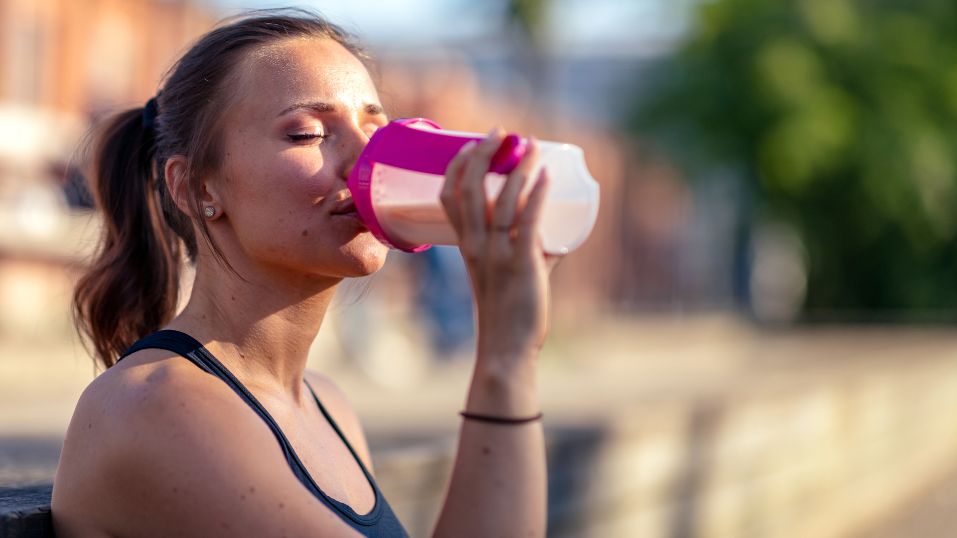 woman drinking a protein shake after a workout