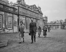 Queen Elizabeth II walks with Henry Somerset, the 10th Duke of Beaufort at the Badminton Horse Trials on April 26, 1957. Credit: Evening Standard/Stringer via Getty Images