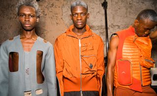 Three African male models modelling various styles of clothing at the London Fashion week.