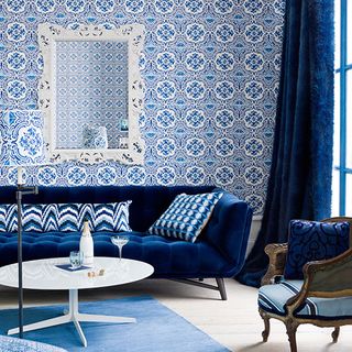 blue themed living room with wallpaper and sofa set