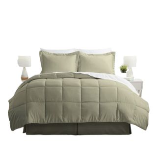 A sage green bedding set on a bed