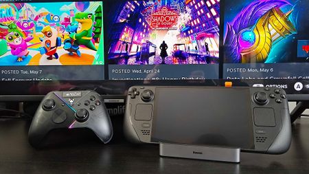 Steam Deck OLED sitting on Baseus docking station next to Asus ROG controller and Samsung TV