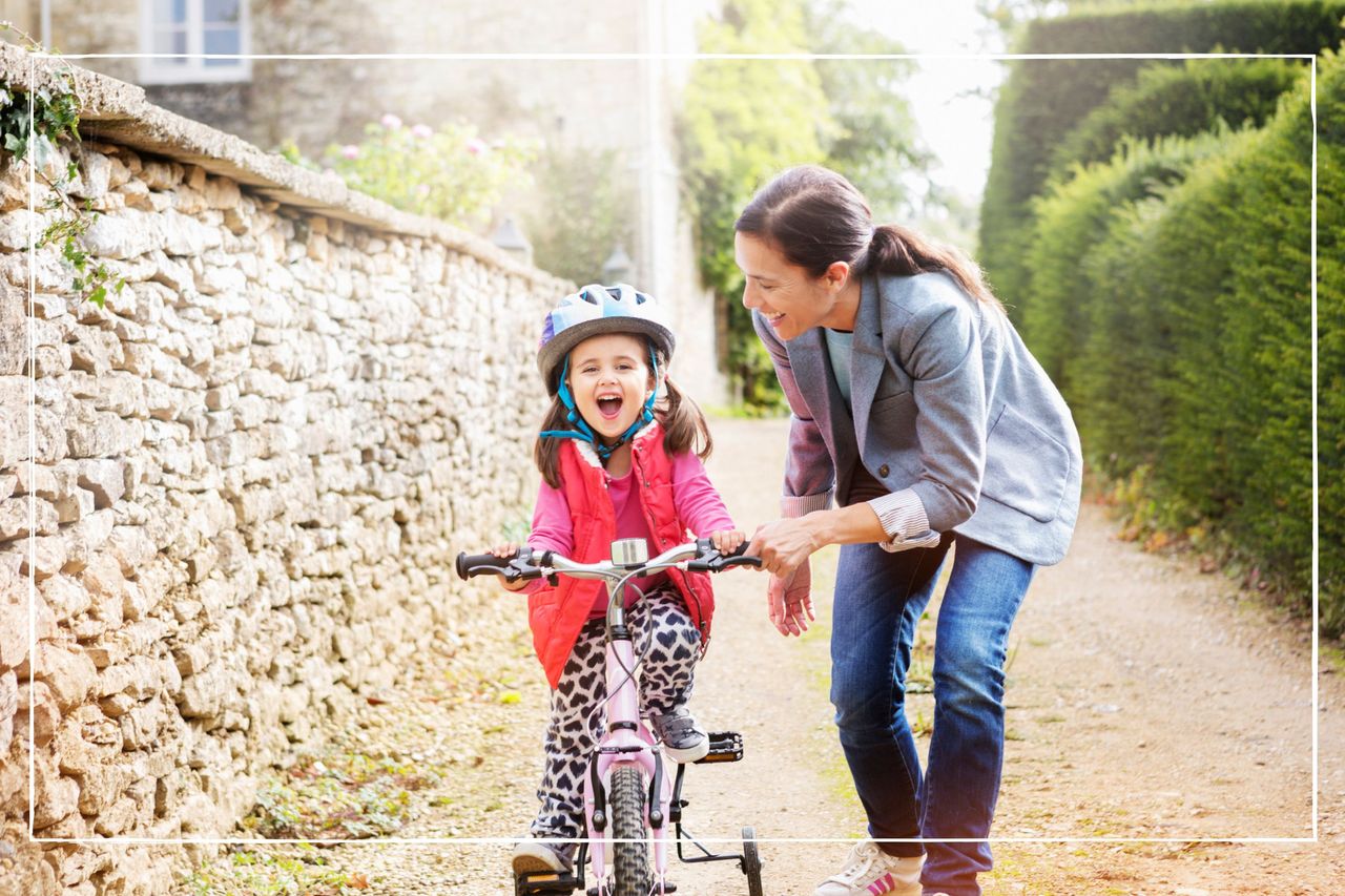 mother supports daughter who is learning cycling