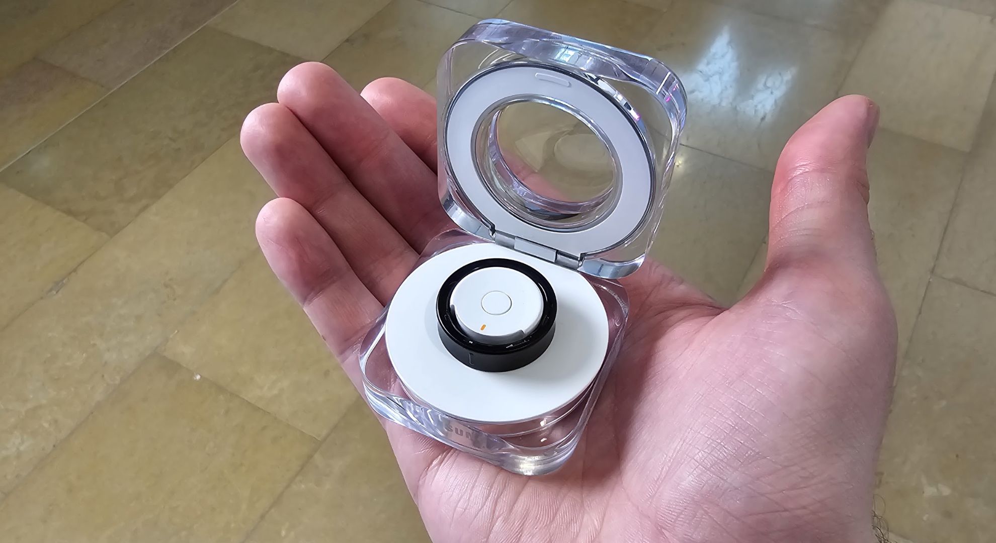 The Samsung Galaxy Ring in a charging case