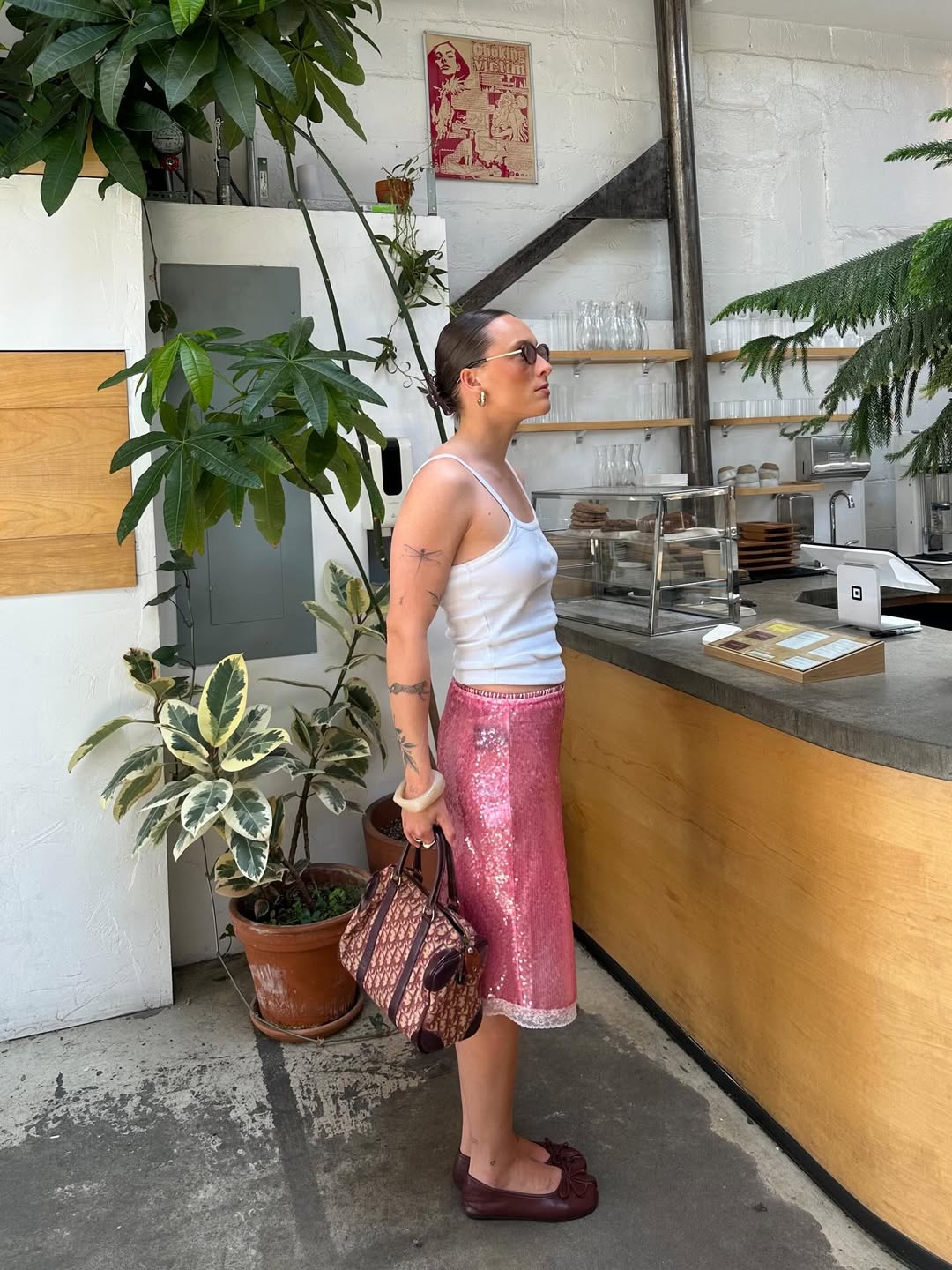 An influencer wearing a pink skirt.