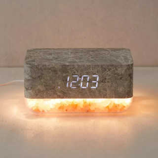 A light-up alarm clock with Himalayan salt bottom and a rocky-looking top surface