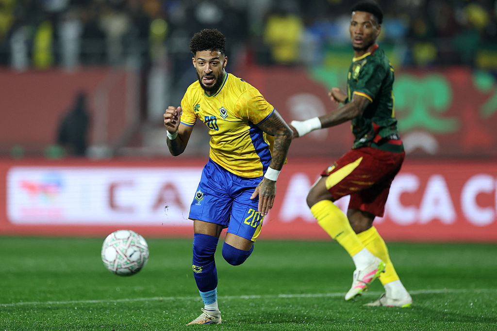 Gabon's forward #20 Denis Bouanga (L) chases the ball during the Africa Cup of Nations (CAN) Group F football match between Cameroon and Gabon at Adrar Stadium in Agadir on December 24, 2025. (Photo by FRANCK FIFE / AFP)