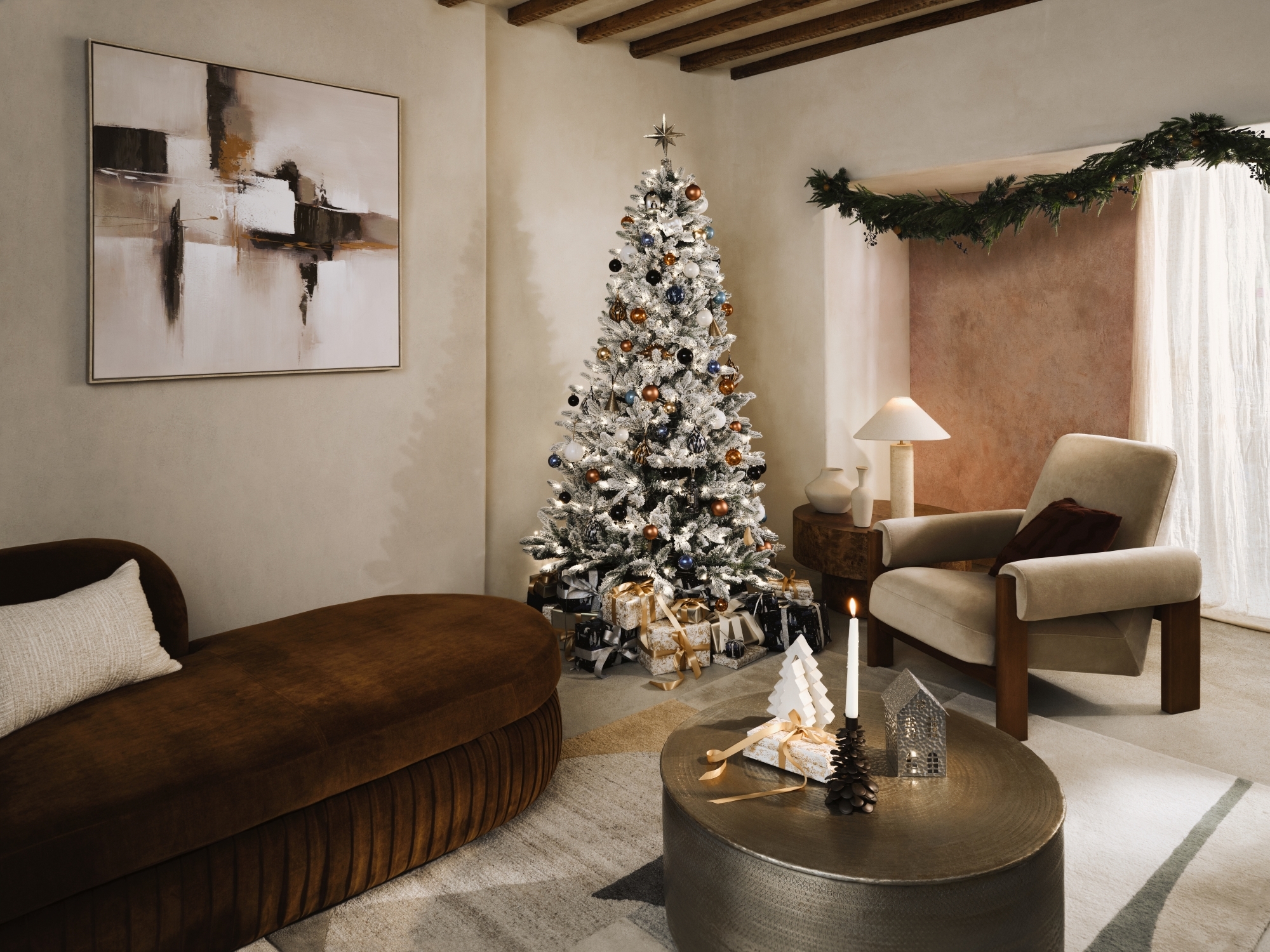 A minimalist living room at Christmas time with a flocked Christmas tree and a garland running along the ceiling
