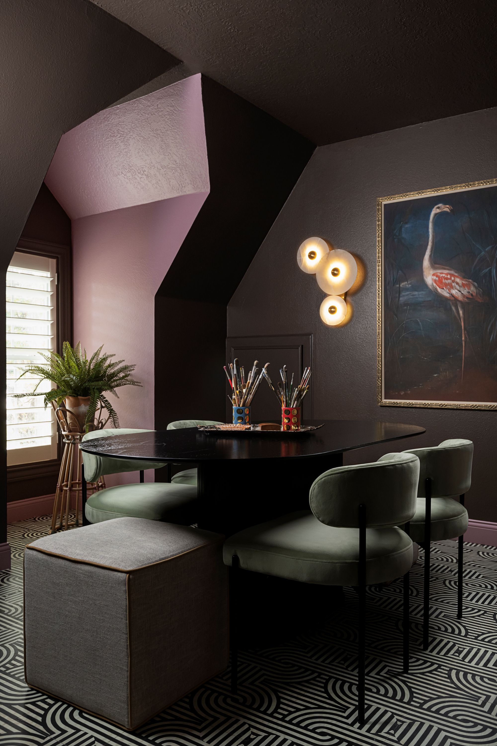 dining room with a patterned rug, green chairs, a black table, and purple paint