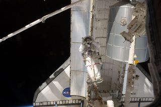 Spacewalker snaps photo with shuttle Atlantis