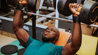 new metabolism study: person performing the dumbbell bench press exercise